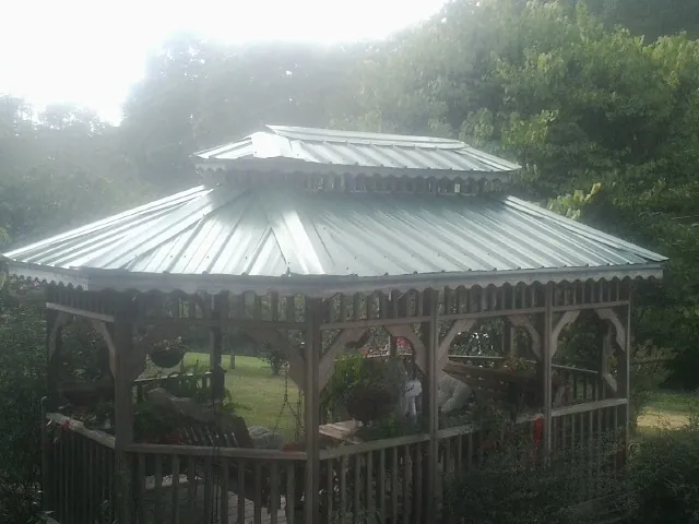 Two tier green metal roof on a garden gazebo in Firth